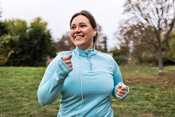Young overweight chubby woman running